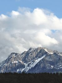 Scenic view of snow covered mountains against sky