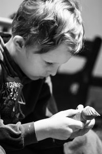 Close-up of boy playing with toy at home