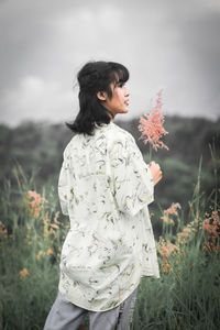 Beautiful woman standing on field