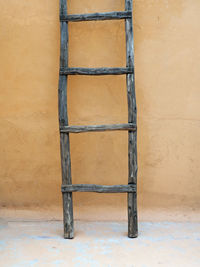 Wooden ladder against wall