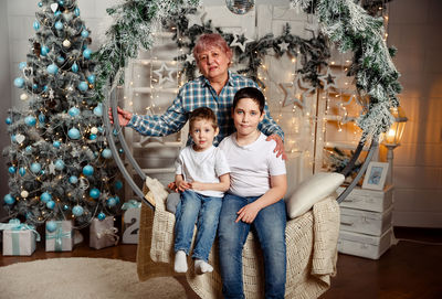 Cheerful grandmother and children exchanging gifts. merry christmas