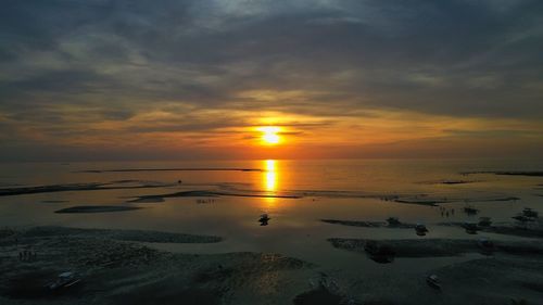 Scenic view of sea against sunset sky