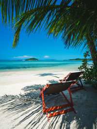 Koh mak island turquoise water, relax chair on white sand beach with coconut palm tree. thailand.