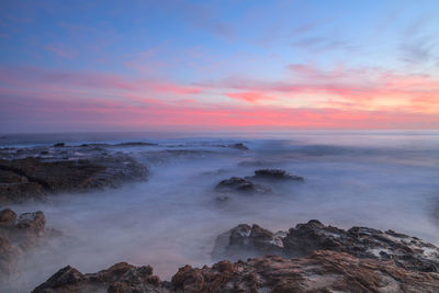 View of rocky beach against the sky