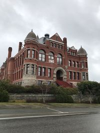 Building by road against sky