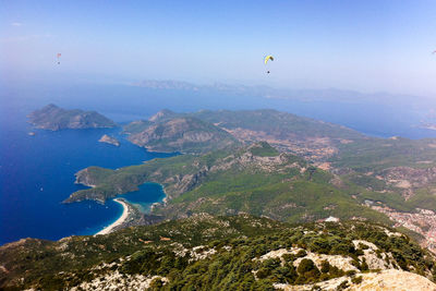 Aerial view of sea and mountain against sky