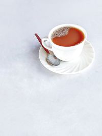 Coffee cup on table against white background