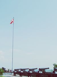 Low angle view of flags against blue sky