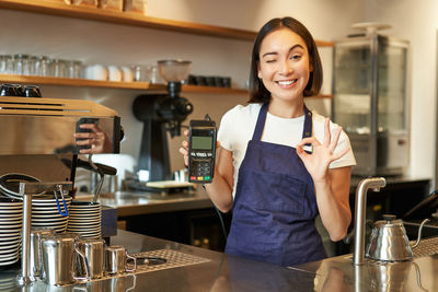 Portrait of young woman using mobile phone