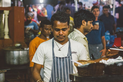 Portrait of people looking at market stall