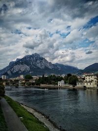 Scenic view of lake by buildings against sky