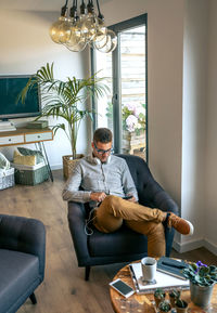 Young man sitting on sofa