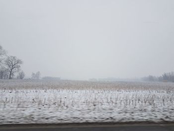 Scenic view of landscape against sky during winter