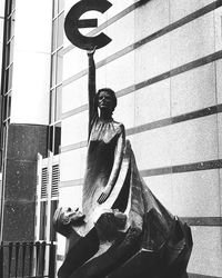 Low angle view of statue against building