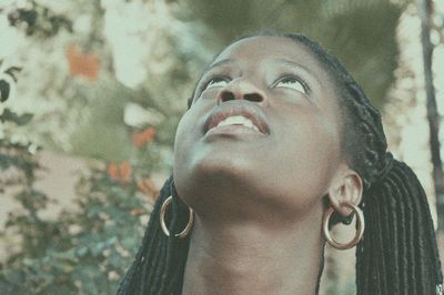 Close-up of young woman looking up