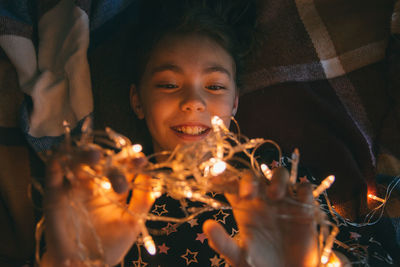 Portrait of smiling young woman holding fire