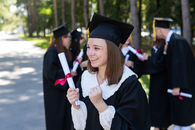 Rear view of woman wearing graduation gown