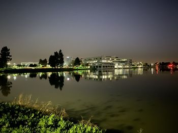 Scenic view of lake against sky at night