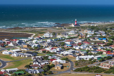 High angle view of buildings and sea against sky