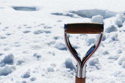 Close-up of shovel handle in snow during winter 
