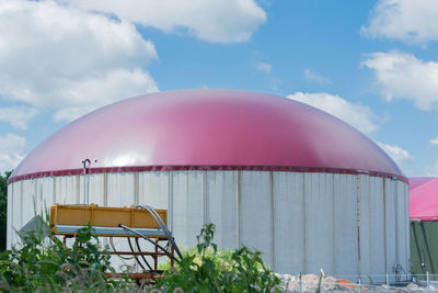 Pink umbrella against sky