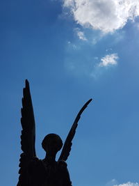 Low angle view of statue against blue sky
