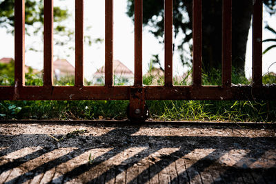 Close-up of metal railing against window