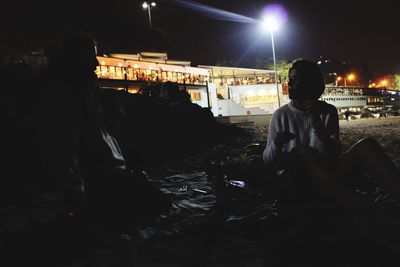 Woman in illuminated city at night