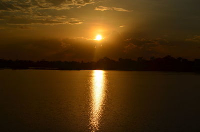 Scenic view of lake against sky during sunset