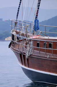 Sailboat moored on sea against sky
