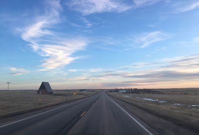 Highway against sky during sunset