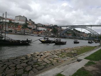 Boats in river with city in background