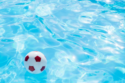 Ball floating in swimming pool