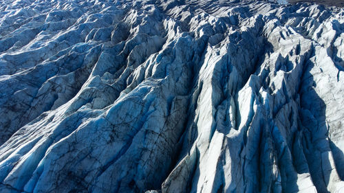 Vatnajokull glacier in iceland, pure blue ice texture at winter season, aerial top view landscape.
