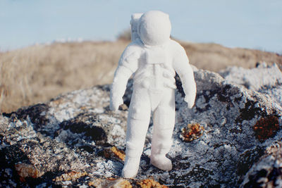 Close-up of white astronaut figurine on field