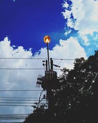 Low angle view of power lines against blue sky