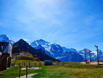 Built structure on field against blue sky