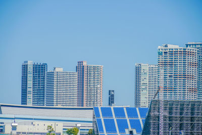 Modern buildings in city against clear sky