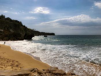 Scenic view of coast, beach and sea against sky.