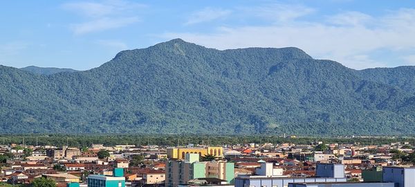 Townscape by mountains against sky