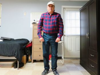 Portrait of man standing on floor at home