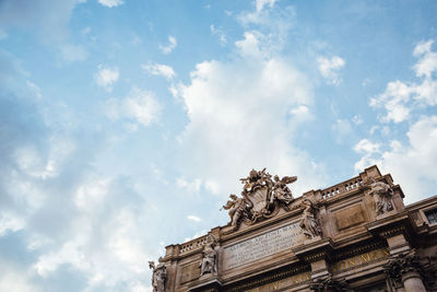 Low angle view of historical building against cloudy sky