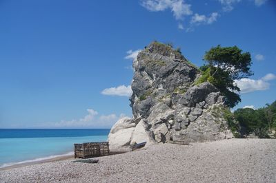 Rocks on beach against sky