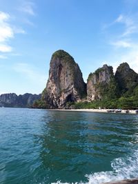 Scenic view of sea and rock formation against sky