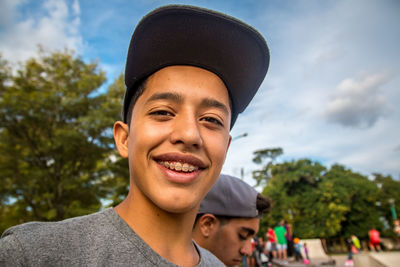 Portrait of smiling young man wearing hat