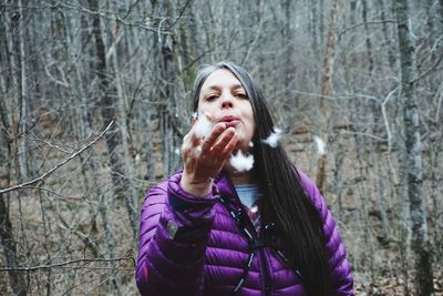 Portrait of woman standing in forest