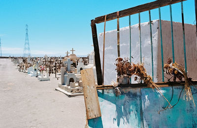 Exterior of abandoned built structure on beach against clear blue sky