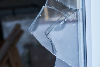 Close-up of broken glass window