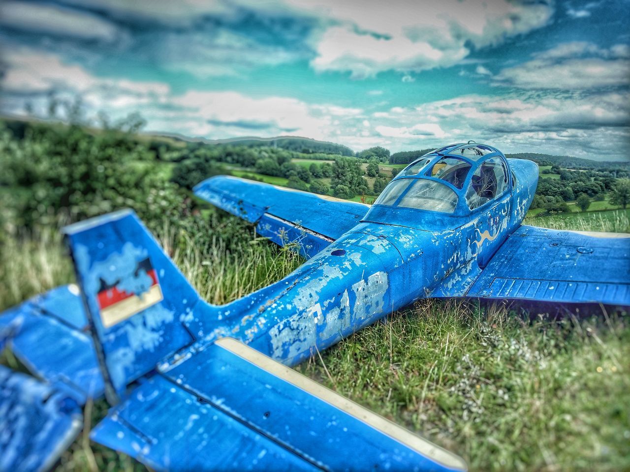 CLOSE-UP OF ABANDONED BOAT ON GRASS