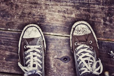 Low section of man standing on tiled floor